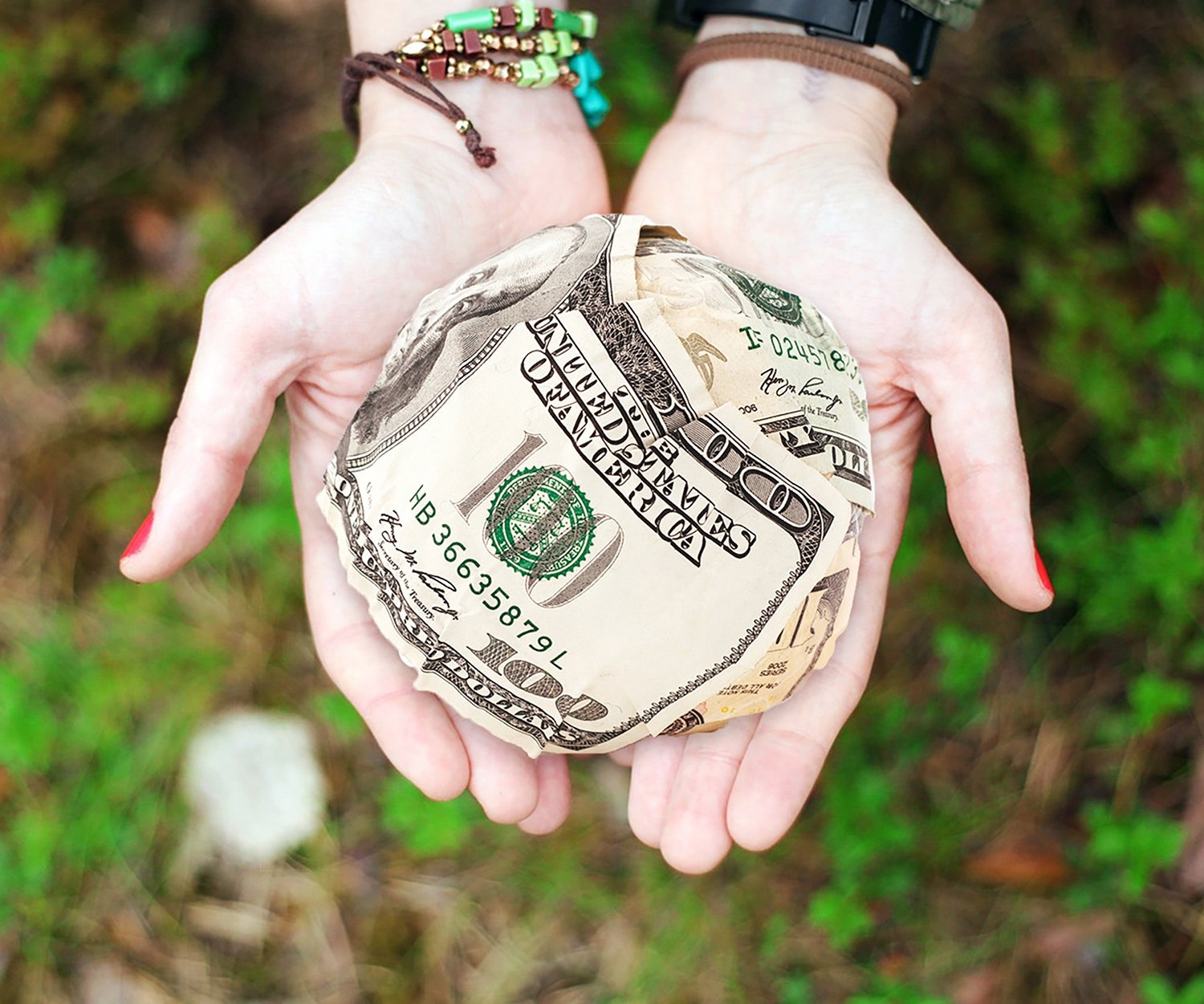 Ball of money in a women's hands