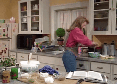 Woman baking in kitchen following a recipe