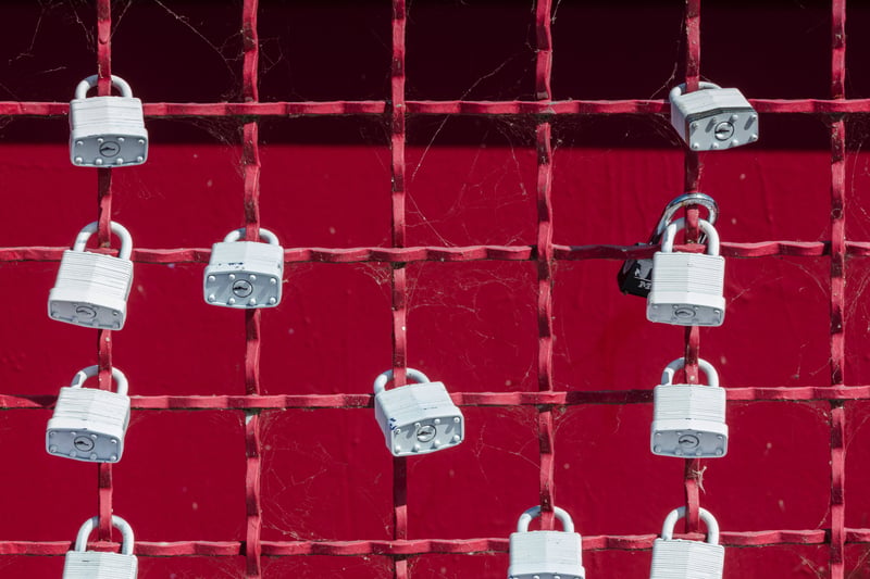 Padlocks on a red fence