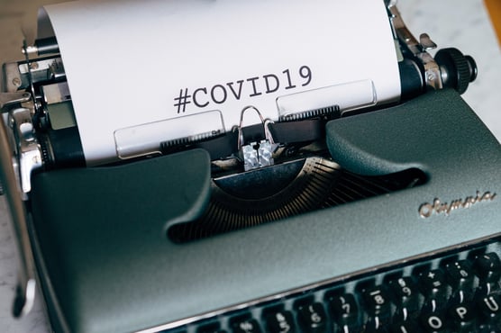 Typewriter printing #COVID19 on paper
