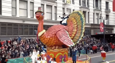 Thanksgiving day parade float with a turkey and pilgrims 